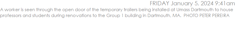 A worker is seen through the open door of the temporary trailers being installed at Umass Dartmouth to house professors and students during renovations to the Group 1 building in Dartmouth, MA.  PHOTO PETER PEREIRA