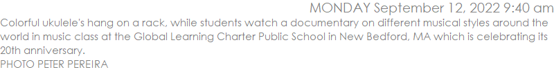 Colorful ukulele's hang on a rack, while students watch a documentary on different musical styles around the world in music class at the Global Learning Charter Public School in New Bedford, MA which is celebrating its 20th anniversary. PHOTO PETER PEREIRA
