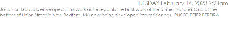 Jonathan Garcia is enveloped in his work as he repoints the brickwork of the former National Club at the bottom of Union Street in New Bedford, MA now being developed into residences.  PHOTO PETER PEREIRA