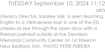Literacy Director, Saralee Salk, is seen teaching English to a Vietnamese man in one of the ESL classes as see through the open door with a fireman painted outside at the Dennison Memorial Community Center on 1st Street in New Bedford, MA.  PHOTO PETER PEREIRA