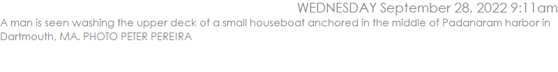 A man is seen washing the upper deck of a small houseboat anchored in the middle of Padanaram harbor in Dartmouth, MA. PHOTO PETER PEREIRA