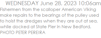 Fishermen from the scalloper American Viking make repairs to the bearings of the pulley used to hoist the dredges when they are out at sea, while docked at State Pier in New Bedford. PHOTO PETER PEREIRA