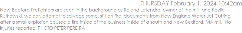 New Bedford firefighters are seen in the background as Roland Letendre, owner of the mill, and Kaylie Rutkowski, welder, attempt to salvage some, still on fire, documents from New England Water Jet Cutting, after a small explosion caused a fire inside of the business inside of a south end New Bedford, MA mill.  No injuries reported. PHOTO PETER PEREIRA