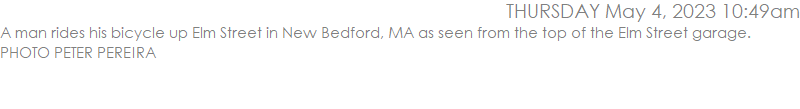 A man rides his bicycle up Elm Street in New Bedford, MA as seen from the top of the Elm Street garage. PHOTO PETER PEREIRA
